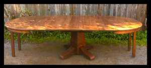 Original Vintage Gustav  Stickley 10 foot pedestal dining table. 54 inch diameter plus 6 leaves, two pairs of hidden drop down legs when open